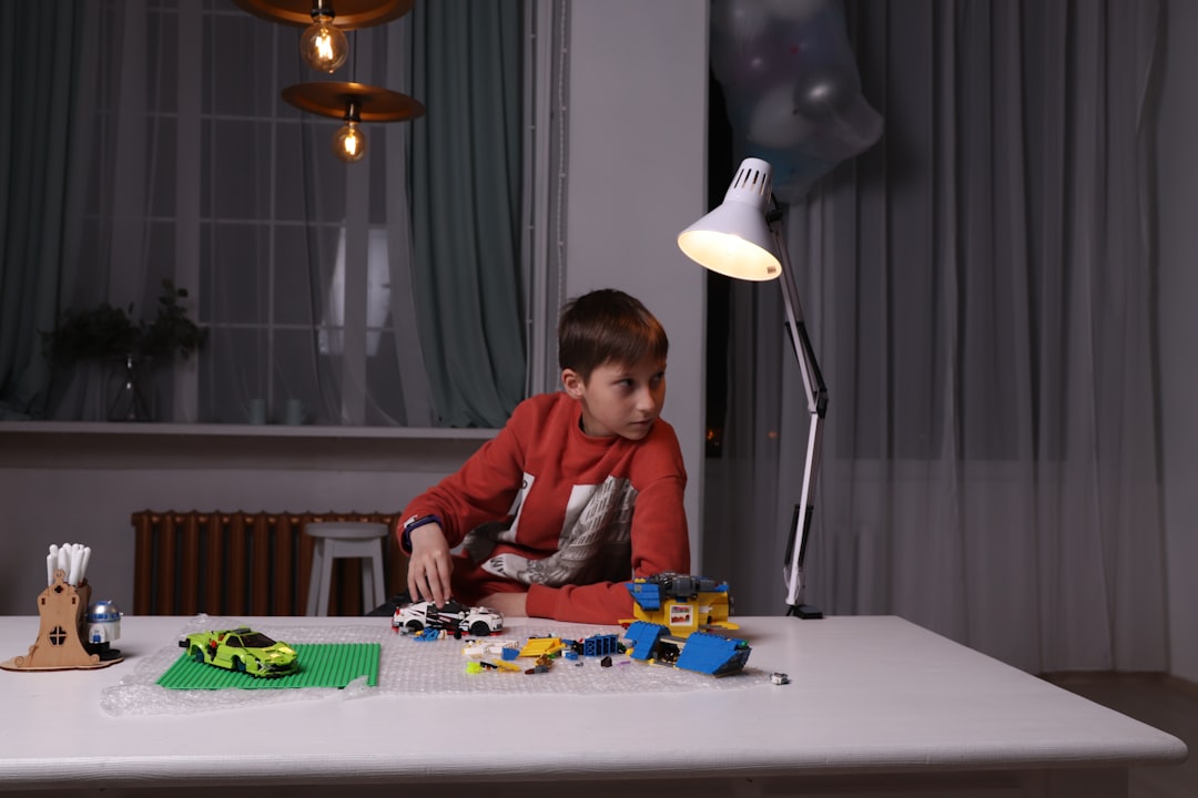 child playing with Lego at the table